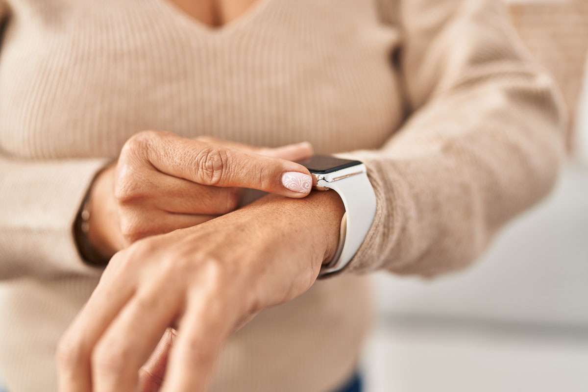 Elderly woman using smartwatch