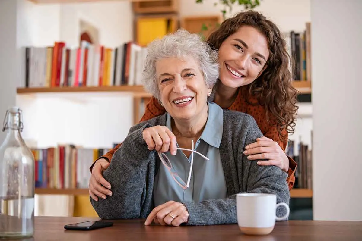 An adult daughter checking in warmly with her older mother at home