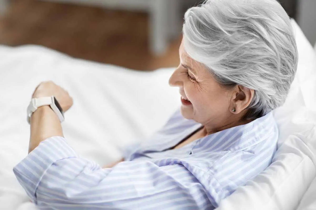 elderly person looking at a smartwatch when they first awake